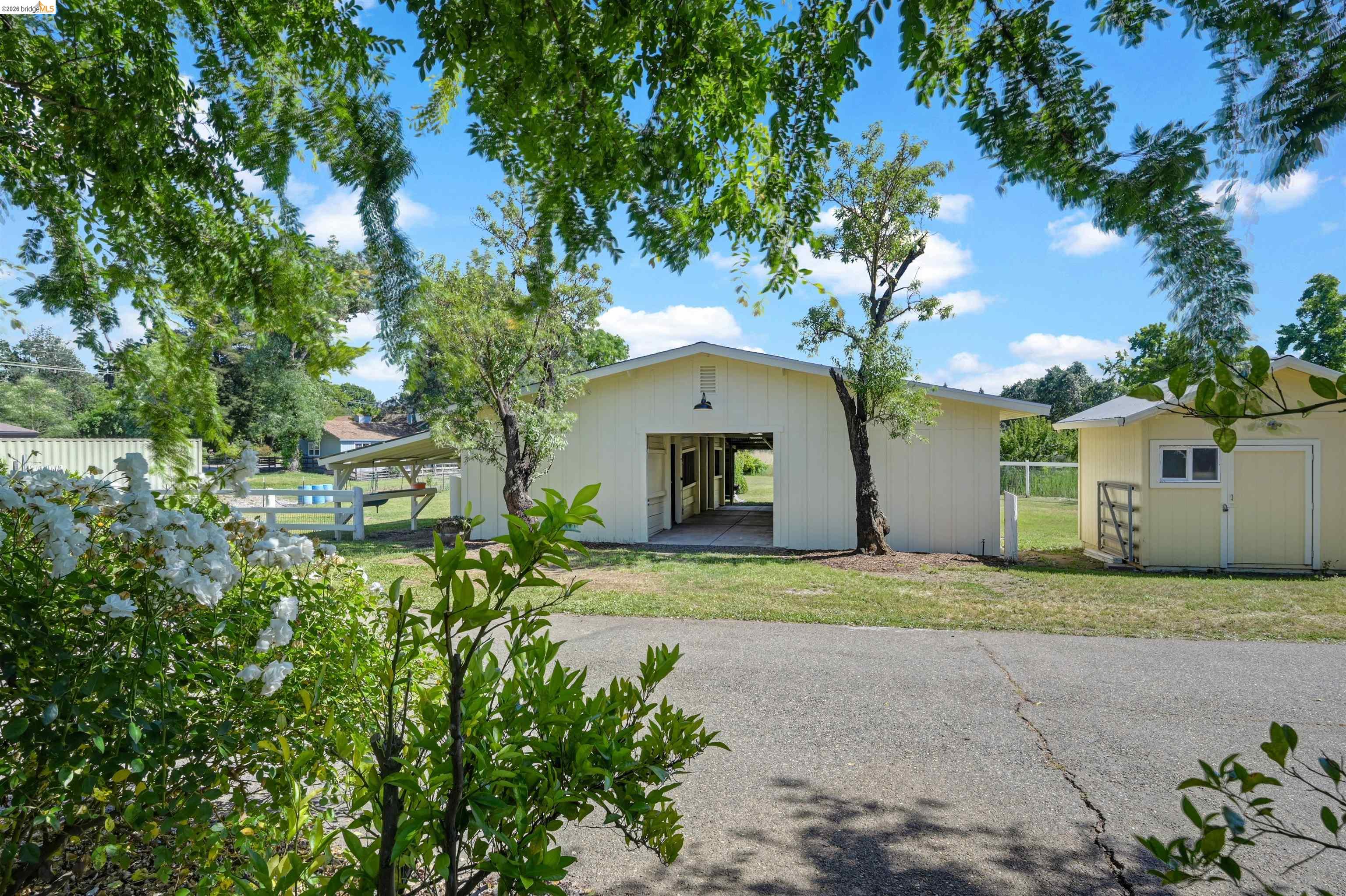 10474 Sheldon Road Elk Grove, CA 95624 - Photo 53 of 83 Light-colored barn structure with an open breezeway