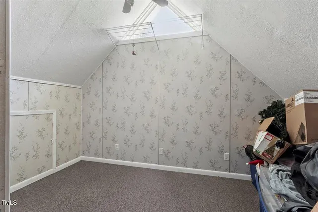 a bedroom with bed and a window