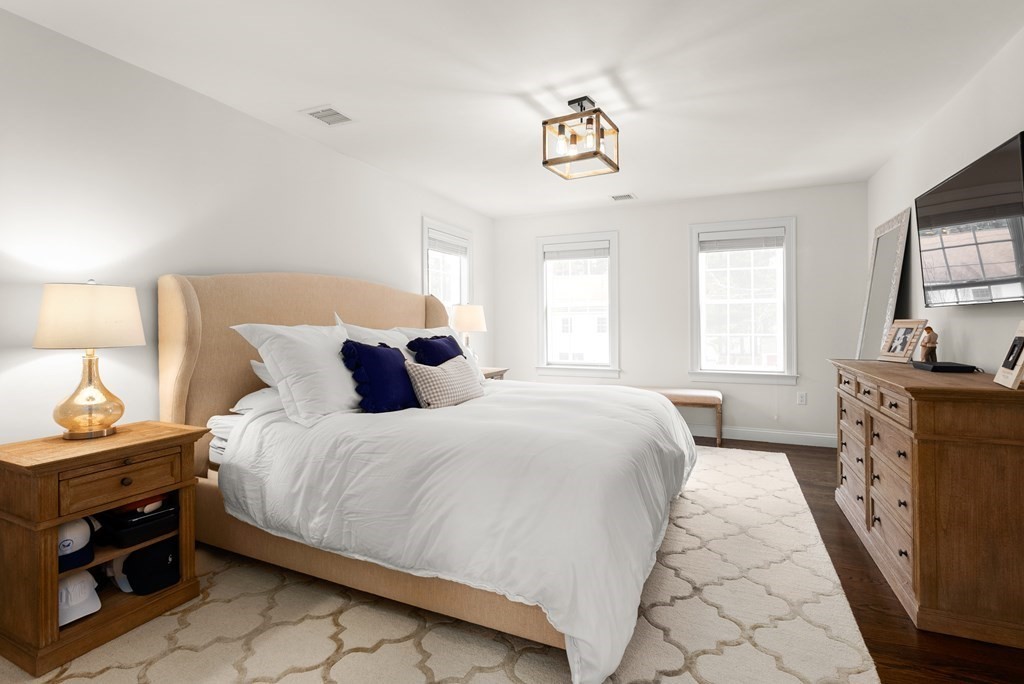 21 July Road Sudbury, MA 01776 - Photo 23 of 41 a bedroom with a bed and a flat tv screen on dresser