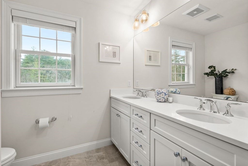 21 July Road Sudbury, MA 01776 - Photo 25 of 41 a bathroom with a double vanity sink a toilet and a window