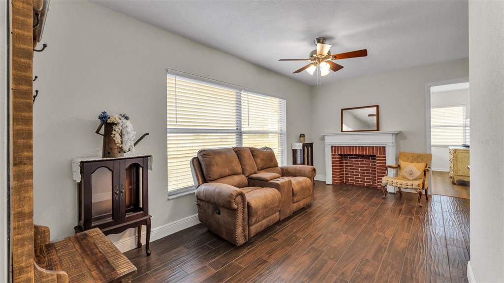 815 West Socrum Loop Road Lakeland, FL 33809 - Photo 14 of 41 a living room with furniture and a fireplace