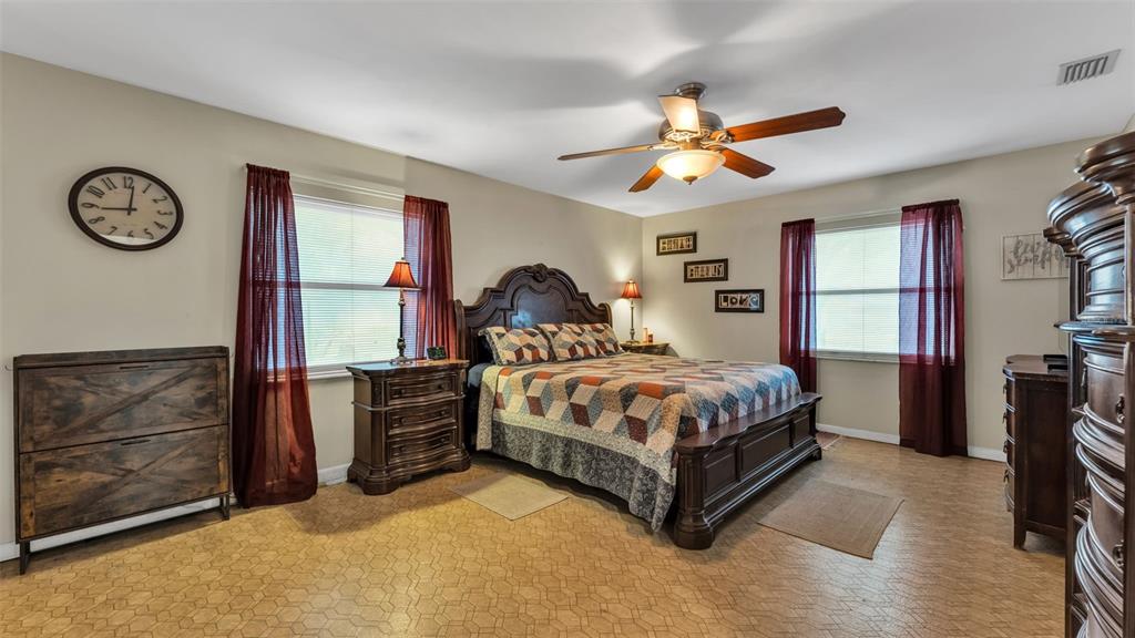 815 West Socrum Loop Road Lakeland, FL 33809 - Photo 17 of 41 a bedroom with a bed and a chandelier