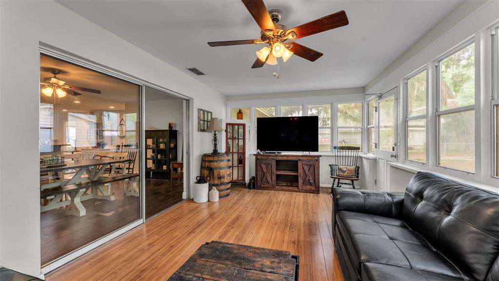 815 West Socrum Loop Road Lakeland, FL 33809 - Photo 18 of 41 a living room with furniture and a flat screen tv with kitchen view