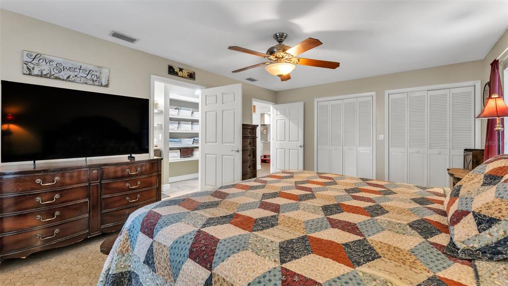815 West Socrum Loop Road Lakeland, FL 33809 - Photo 19 of 41 a bedroom with a bed and a flat screen tv in a dresser