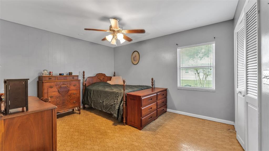 815 West Socrum Loop Road Lakeland, FL 33809 - Photo 22 of 41 a bed room with a bed and a ceiling fan