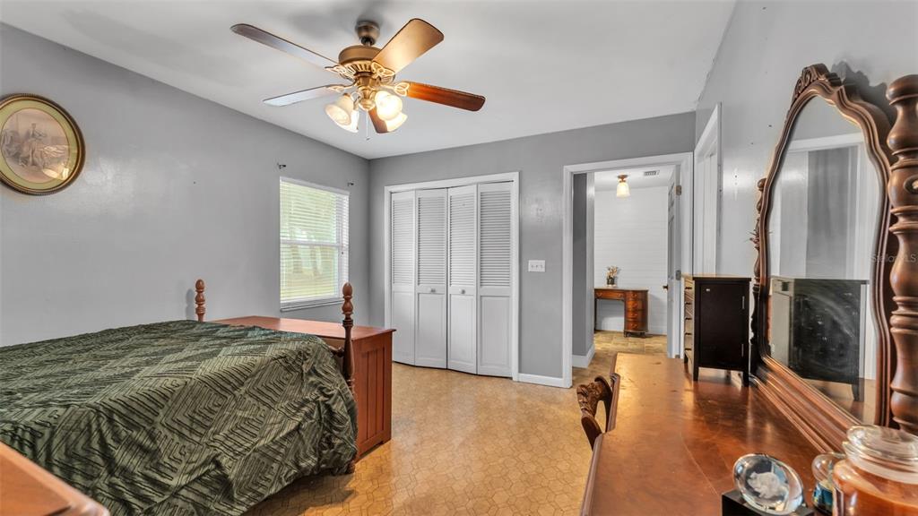 815 West Socrum Loop Road Lakeland, FL 33809 - Photo 23 of 41 a spacious bedroom with a bed and a chandelier