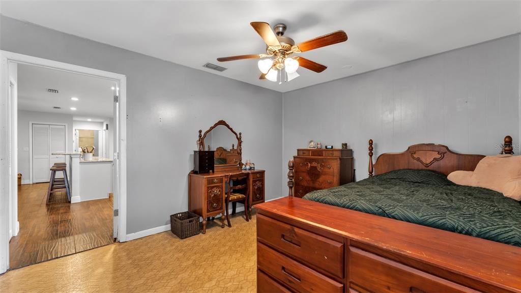 815 West Socrum Loop Road Lakeland, FL 33809 - Photo 24 of 41 a bedroom with a bed and a chandelier