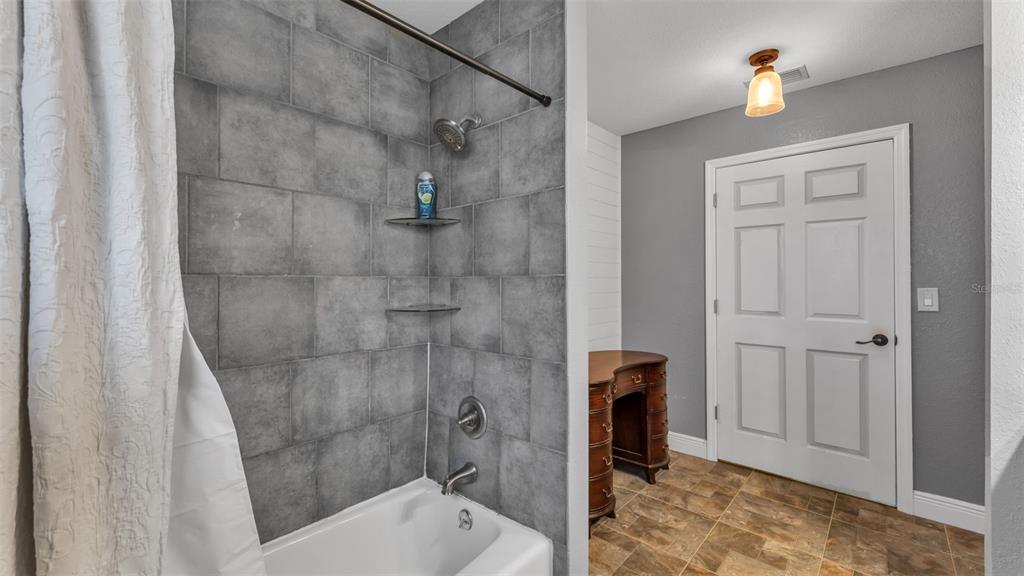 815 West Socrum Loop Road Lakeland, FL 33809 - Photo 26 of 41 a bathroom with a shower and toilet