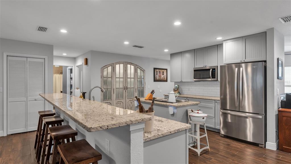 815 West Socrum Loop Road Lakeland, FL 33809 - Photo 3 of 41 a kitchen with stainless steel appliances granite countertop a sink refrigerator and cabinets