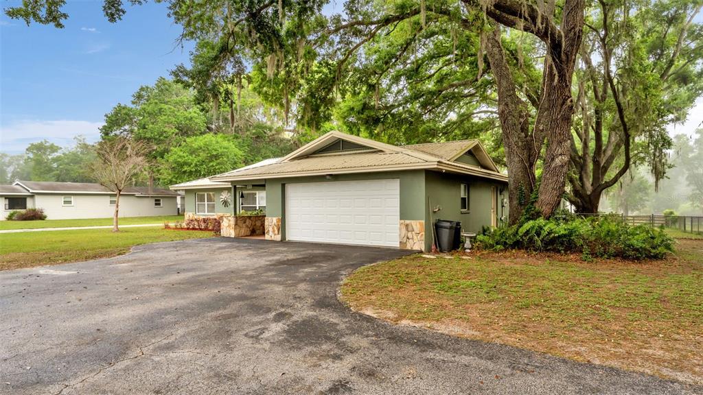 815 West Socrum Loop Road Lakeland, FL 33809 - Photo 40 of 41 a front view of a house with a yard and garage