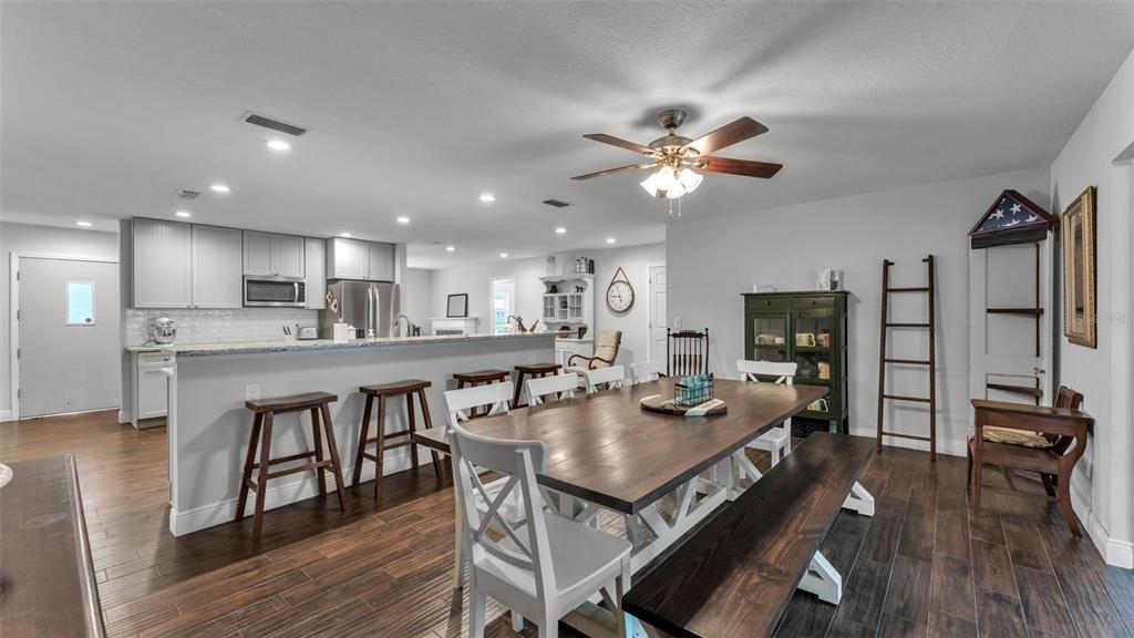 815 West Socrum Loop Road Lakeland, FL 33809 - Photo 4 of 41 a view of a dining room with furniture a chandelier and wooden floor
