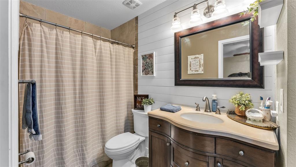815 West Socrum Loop Road Lakeland, FL 33809 - Photo 5 of 41 a bathroom with a sink a toilet and shower curtain