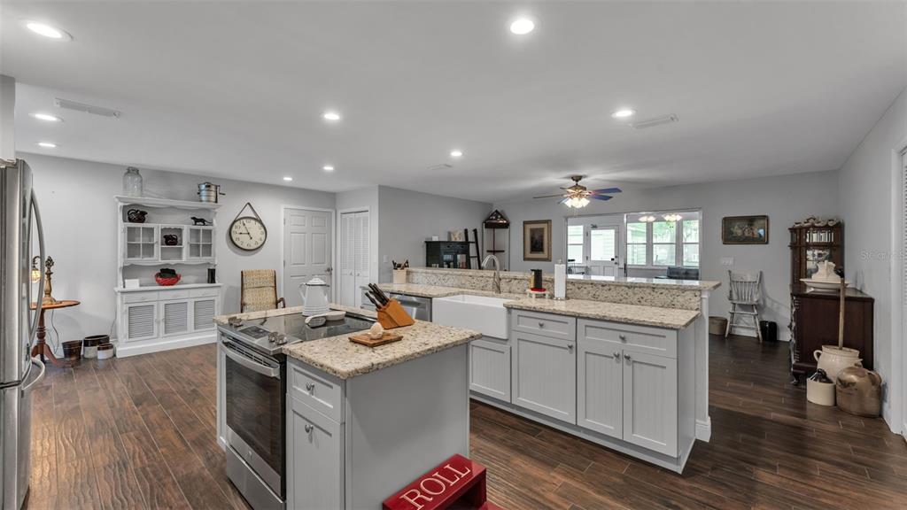815 West Socrum Loop Road Lakeland, FL 33809 - Photo 9 of 41 a kitchen with stainless steel appliances granite countertop a sink stove and wooden floor