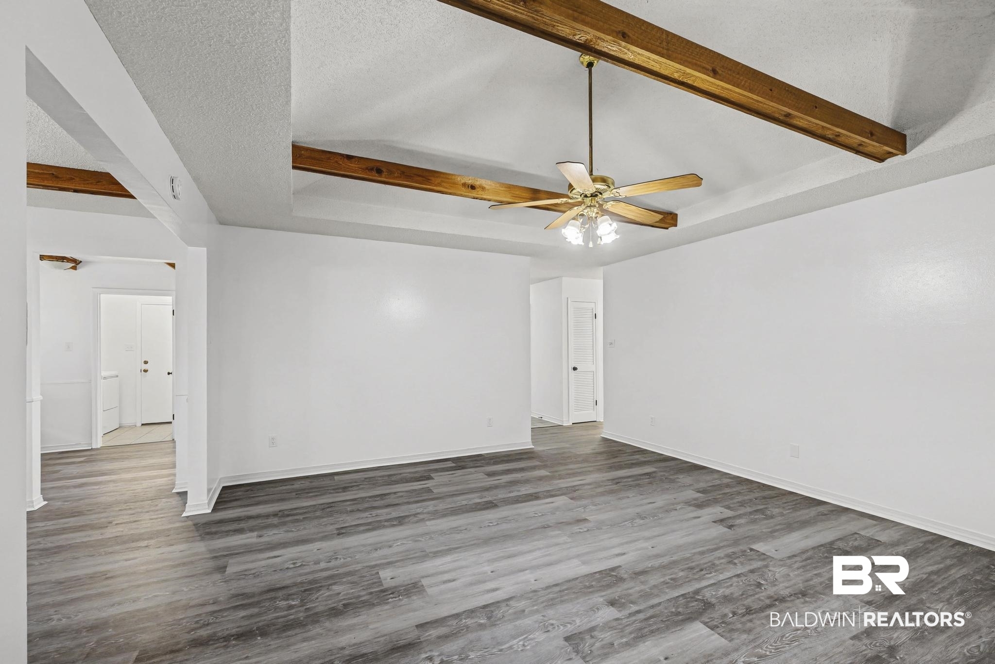 2776 Santa Rosa Circle Lillian, AL 36549 - Photo 17 of 48 Unfurnished room with beam ceiling, a ceiling fan, and wood finished floors