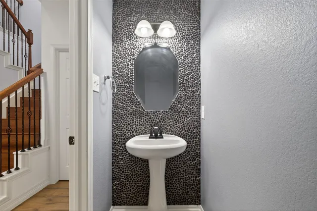 a view of an empty room with wooden floor and closet