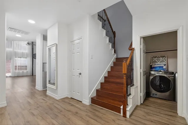 a view of entryway with wooden floor and stairs
