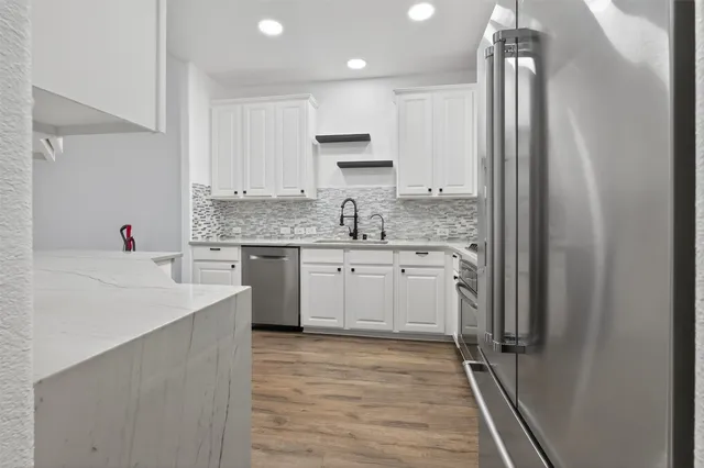 a kitchen with a sink stove and refrigerator
