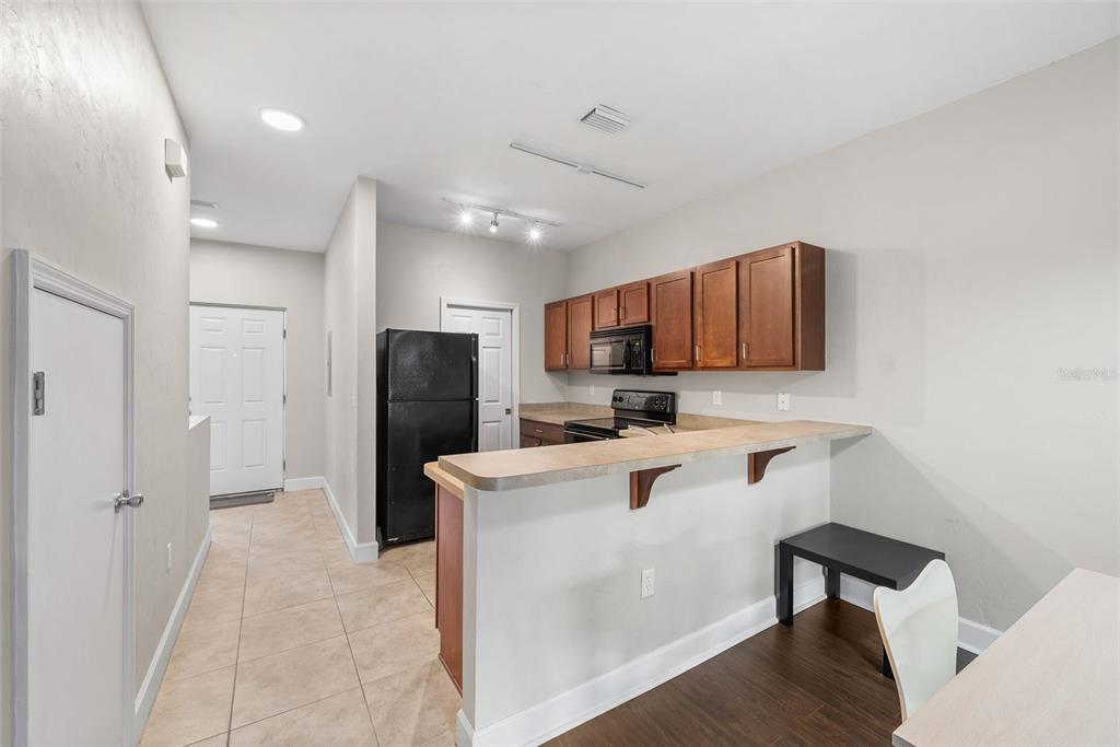 2927 Southwest 35th Place, Unit 113 Gainesville, FL 32608 - Photo 10 of 27 a living room with stainless steel appliances furniture a rug and a view of kitchen