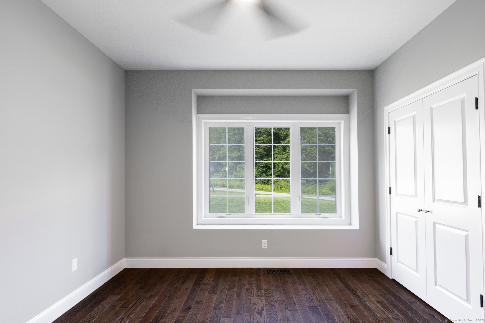 10 Maple View Trail Litchfield, CT 06759 - Photo 18 of 39 an empty room with wooden floor and windows