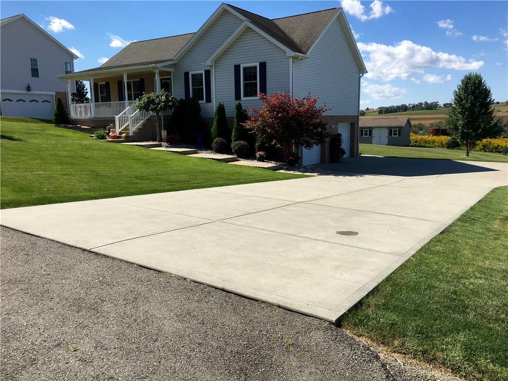 216 Grandma's Road Mount Pleasant, PA 15666 - Photo 4 of 25 Concrete driveway and extra-wide oversized two-car garage. Notice the wonderful landscaping and Japanese Maple tree!