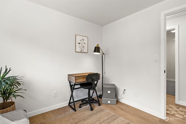 a work room with furniture and wooden floor