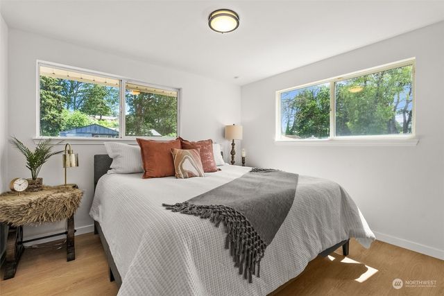 a bed sitting in a bedroom next to a window