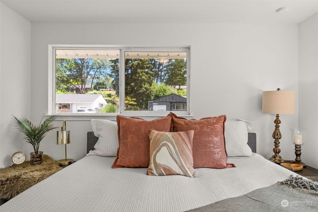 a bedroom with a large bed and a large window