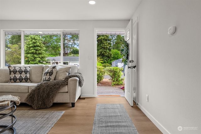 a living room with furniture and a large window