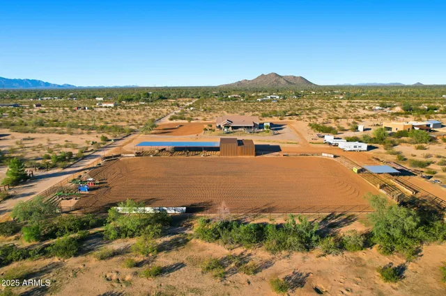a living room with a fireplace and a large window