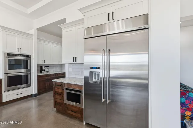 a bedroom with a large bed and wooden floor