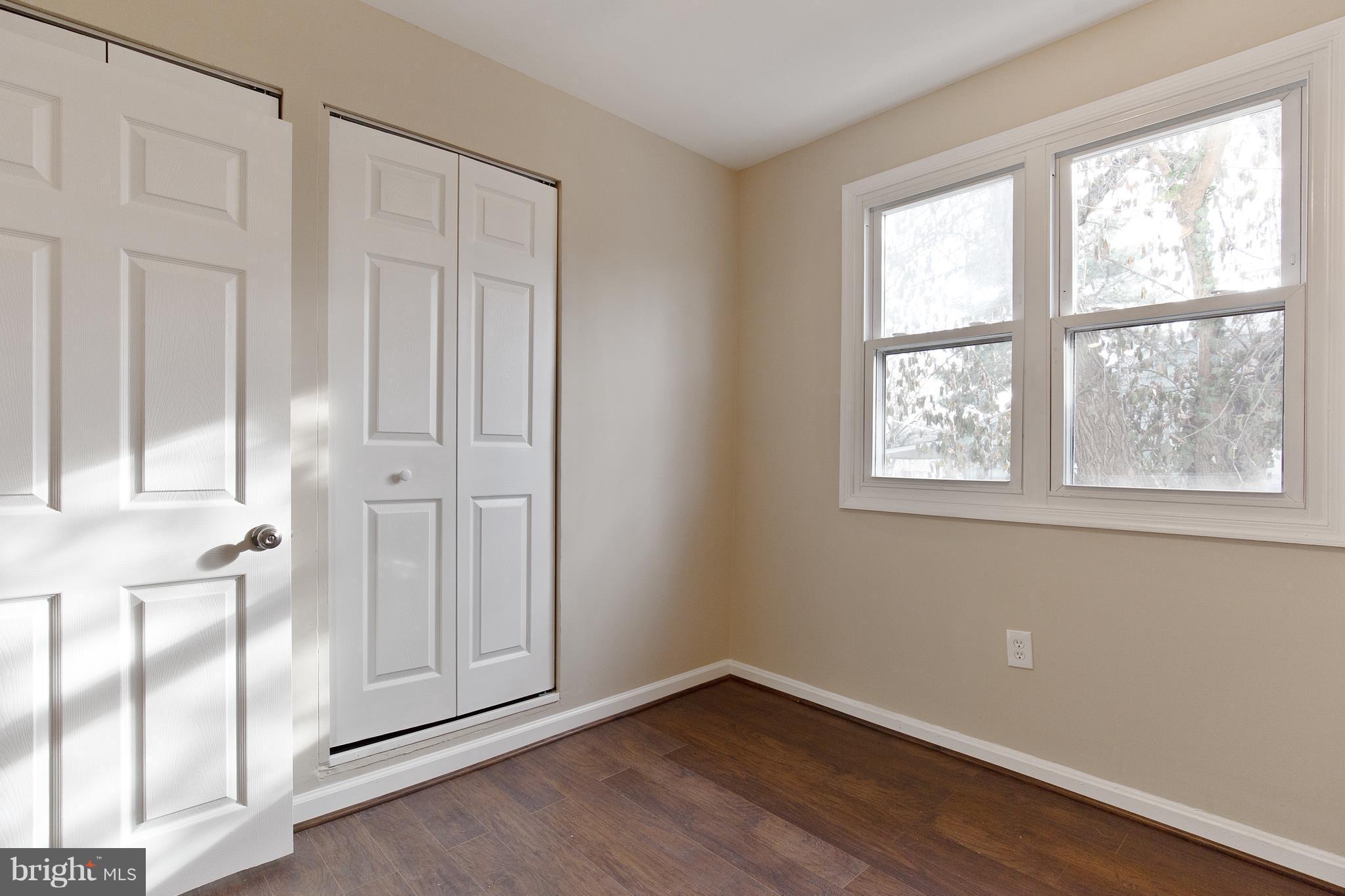 7700 Muncy Road Landover, MD 20785 - Photo 18 of 29 an empty room with wooden floor and windows
