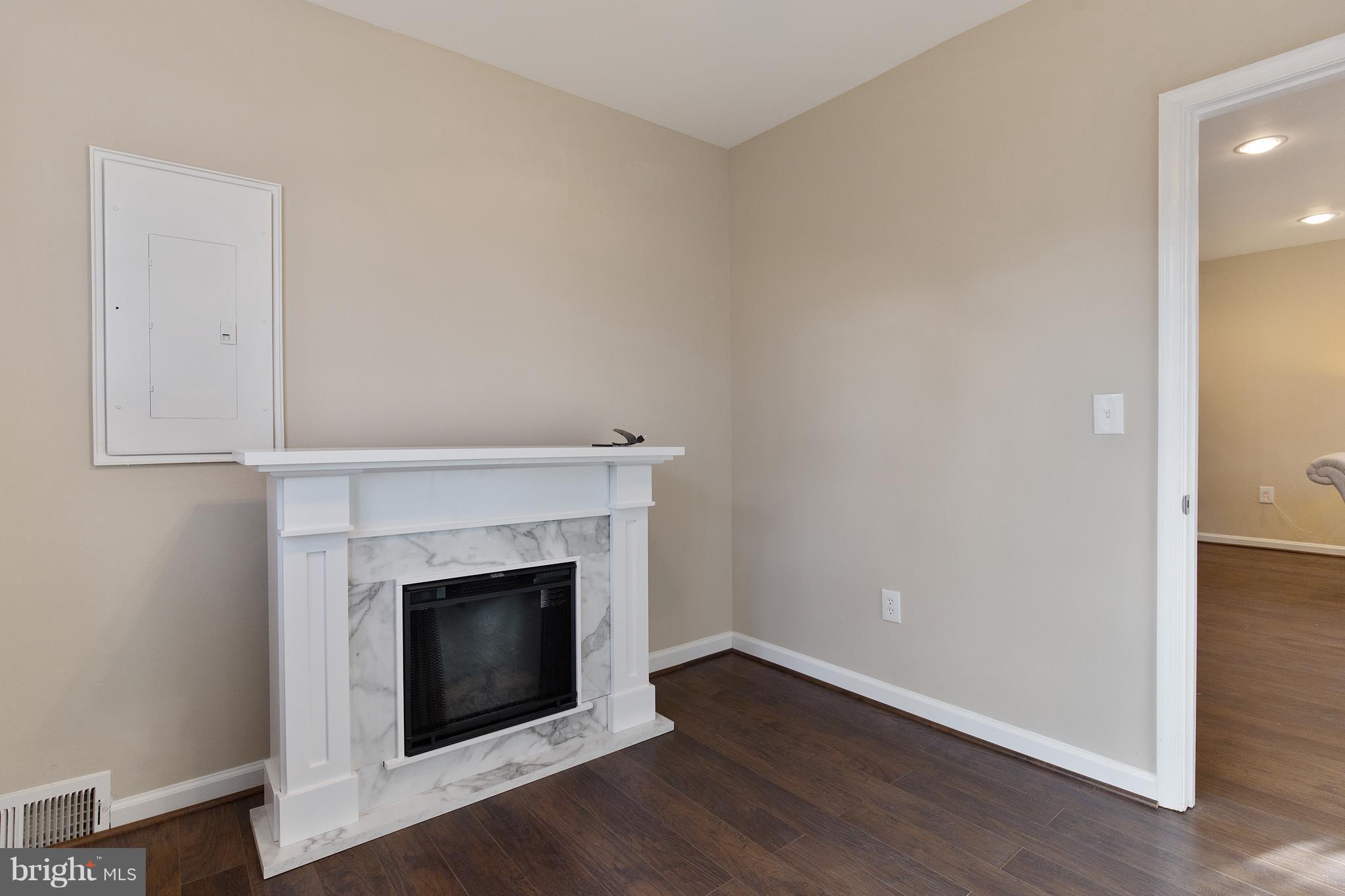 7700 Muncy Road Landover, MD 20785 - Photo 20 of 29 an empty room with wooden floor and fireplace