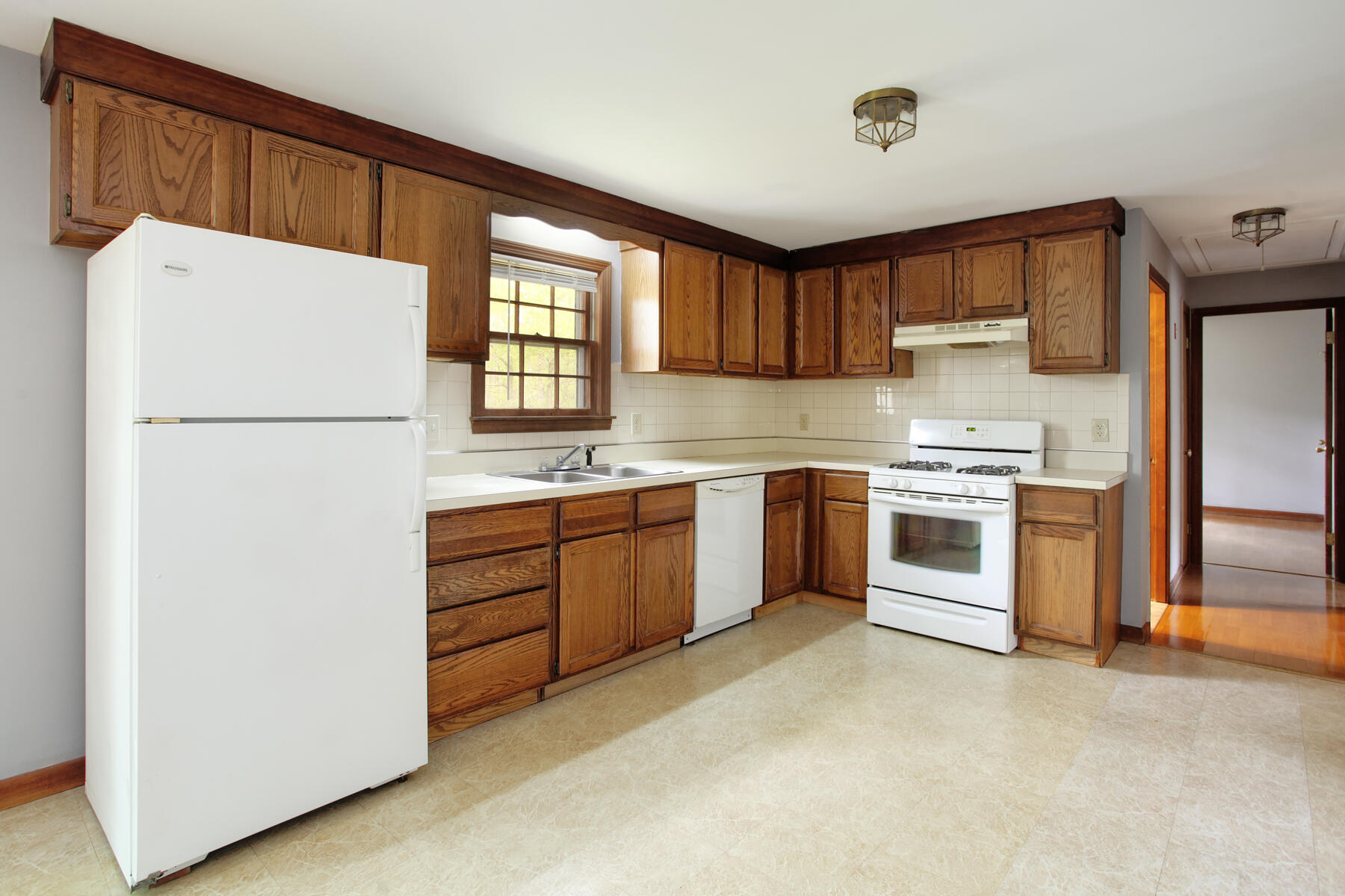 29 Stub Toe Road Cotuit, MA 02635 - Photo 8 of 21 a kitchen with white cabinets and white appliances