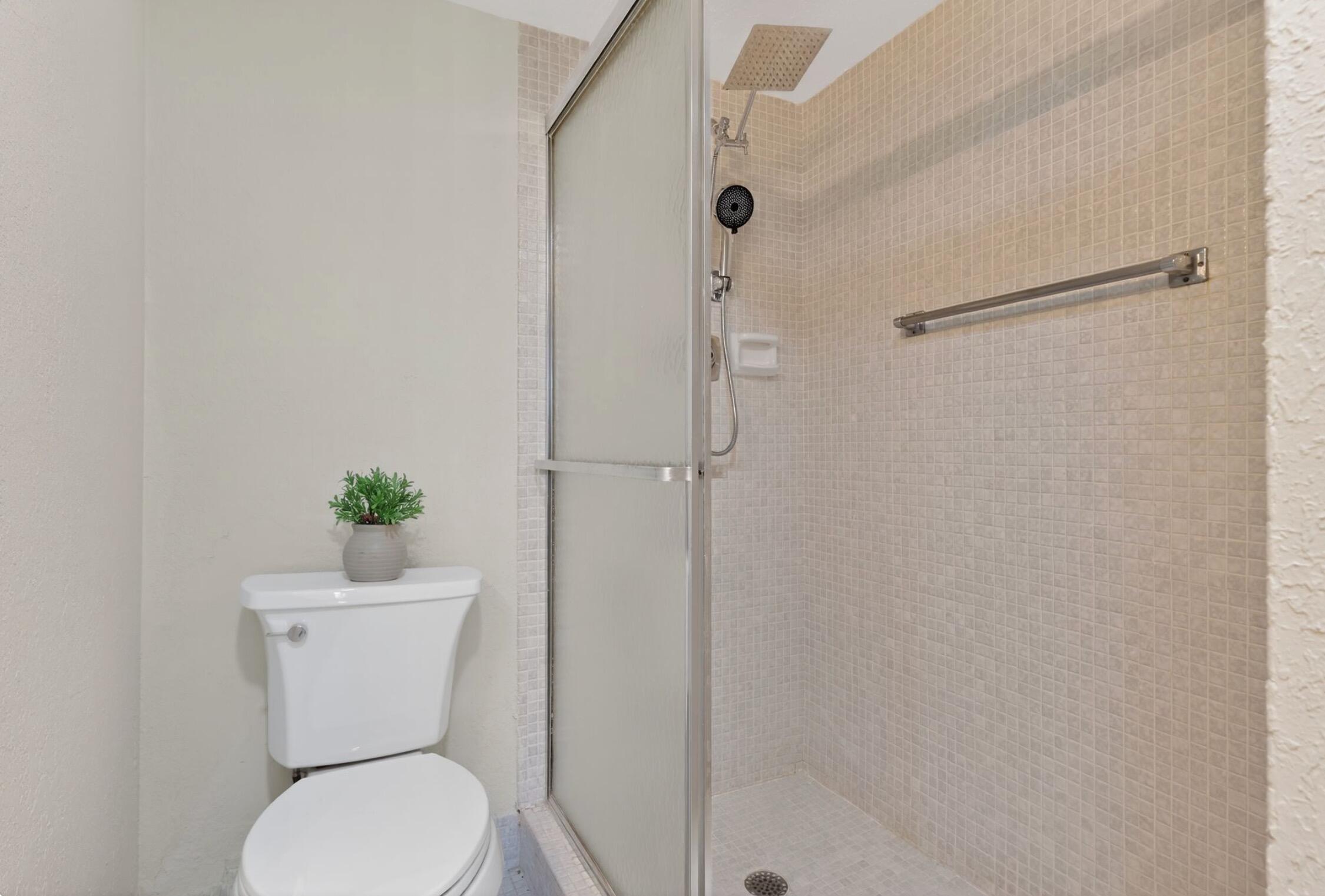 2012 Hythe A, Unit 2012 Boca Raton, FL 33434 - Photo 15 of 15 a white toilet sitting next to a bath tub