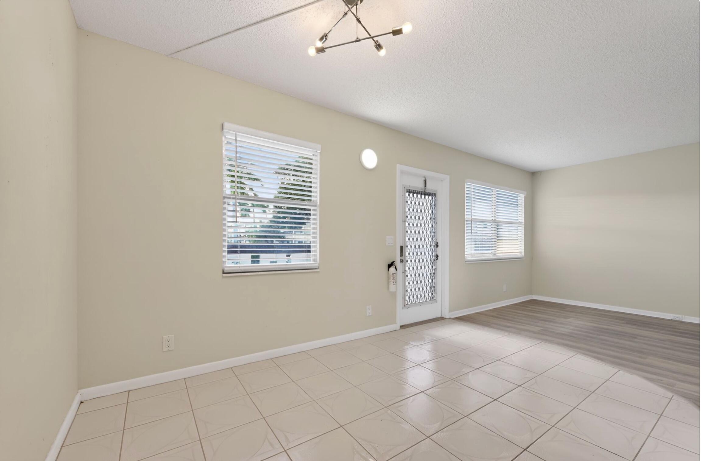 2012 Hythe A, Unit 2012 Boca Raton, FL 33434 - Photo 6 of 15 an empty room with windows and fan