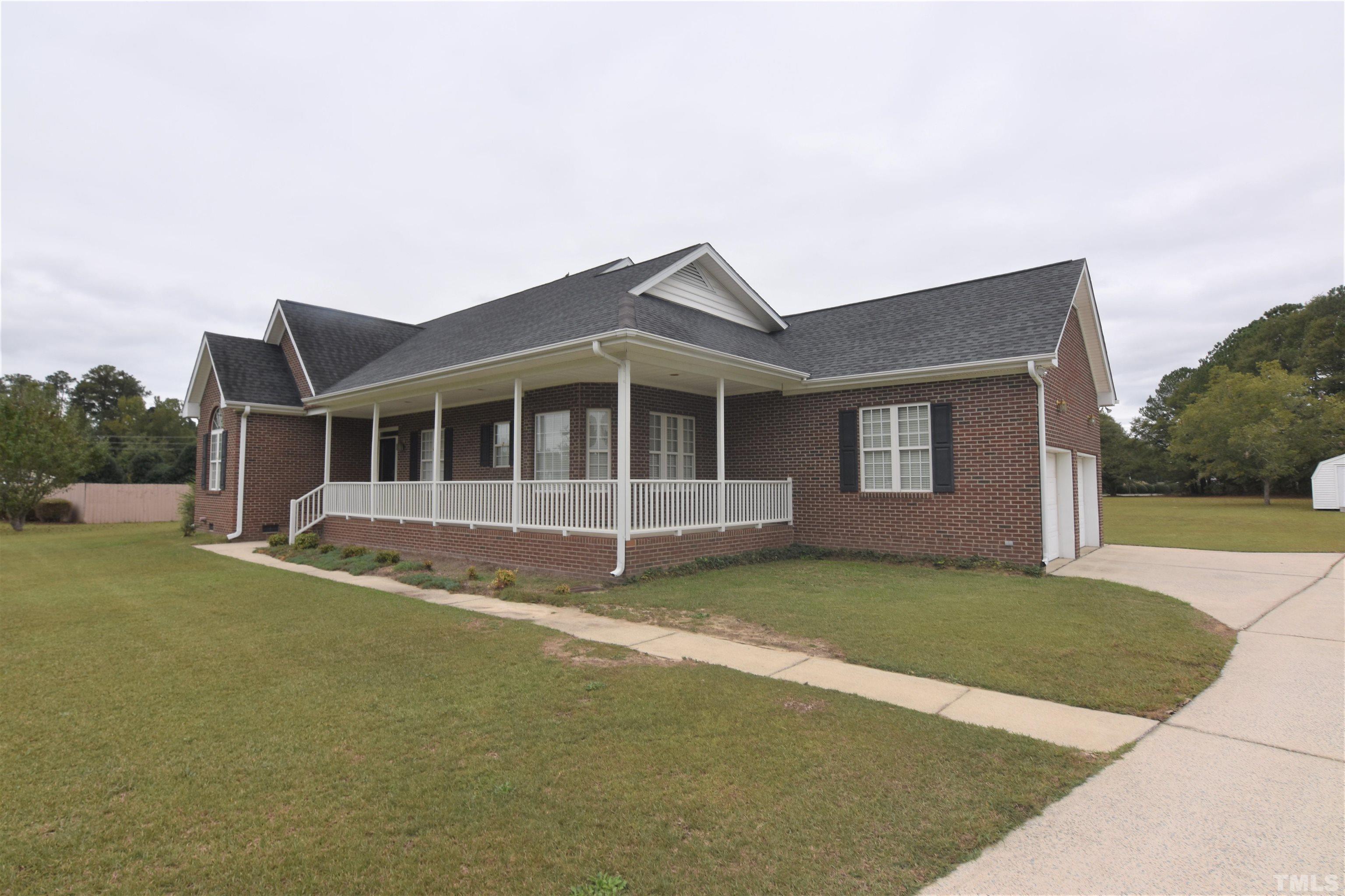 1025 Red Brick Road Garner, NC 27529 - Photo 2 of 30 a front view of a house with a garden