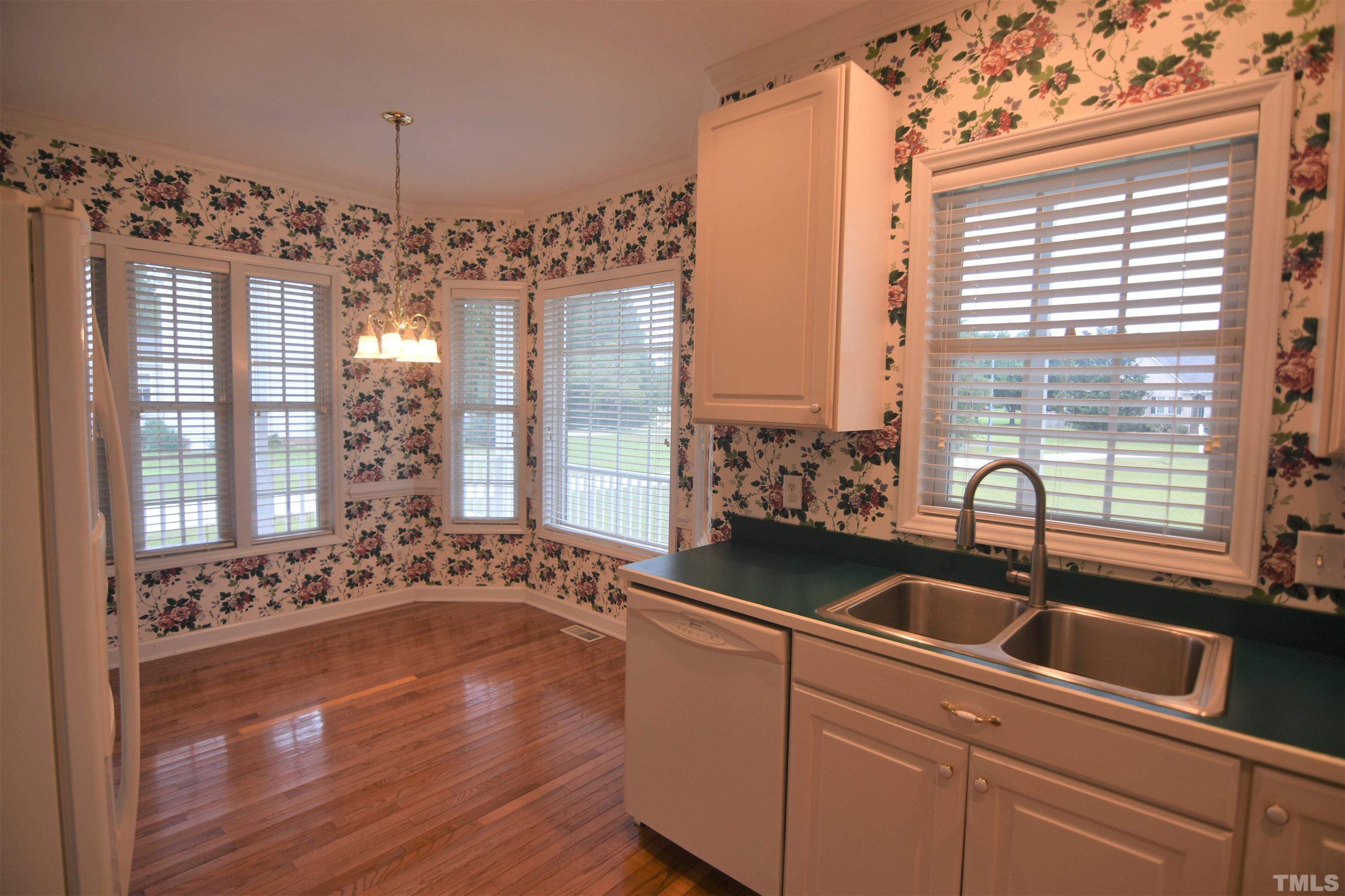 1025 Red Brick Road Garner, NC 27529 - Photo 12 of 30 a kitchen with a sink and chandelier