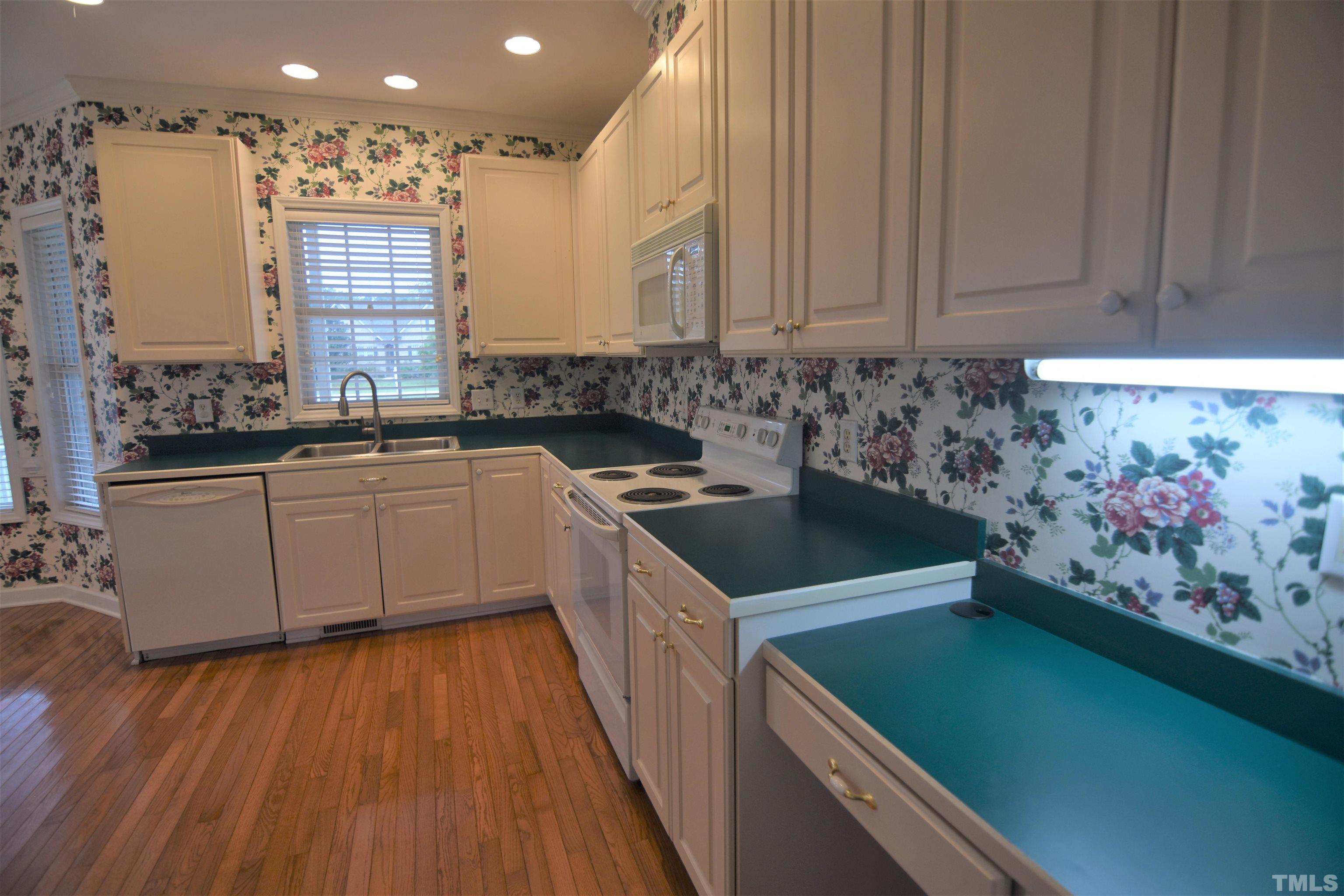 1025 Red Brick Road Garner, NC 27529 - Photo 13 of 30 a kitchen that has a sink and a stove in it