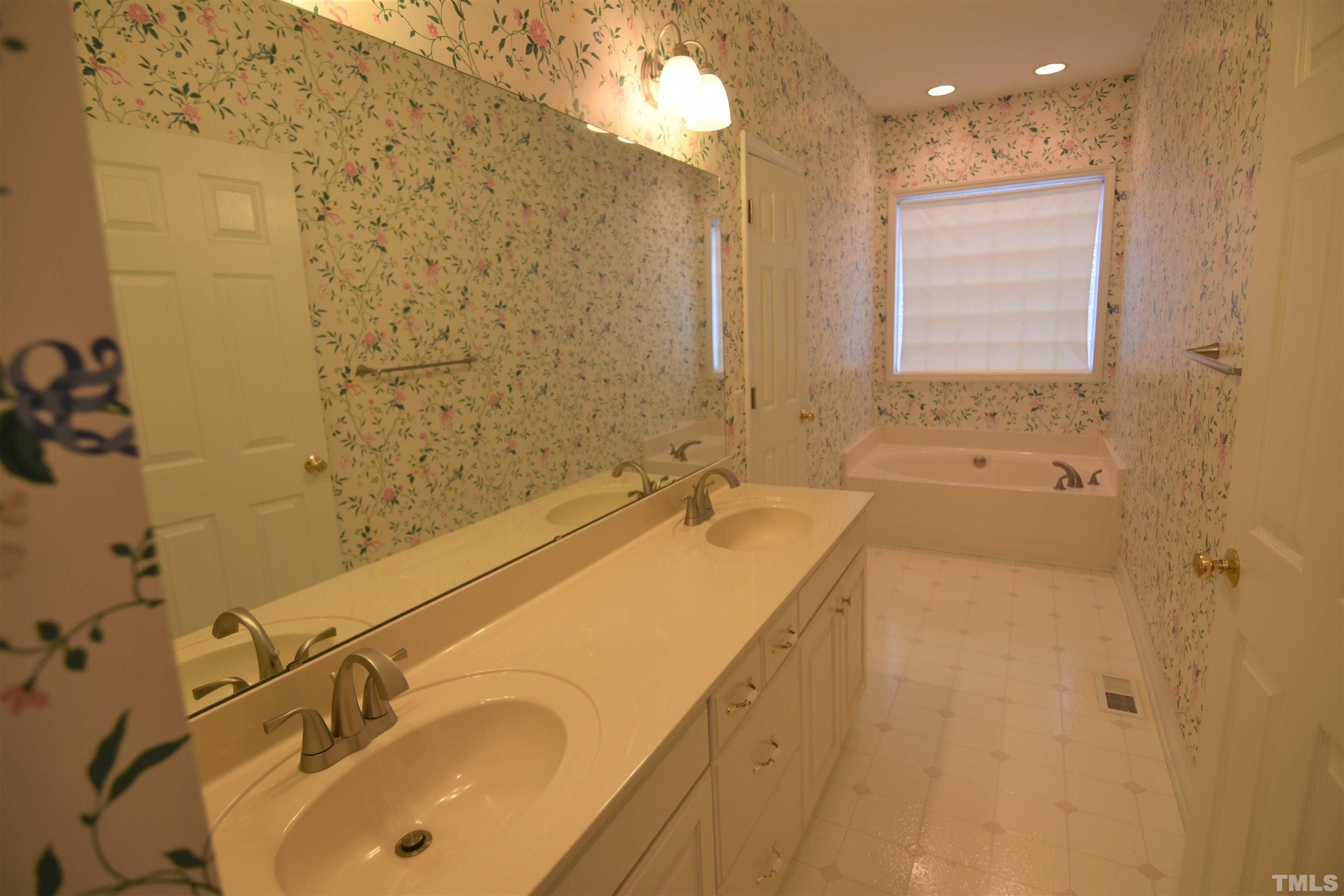 1025 Red Brick Road Garner, NC 27529 - Photo 21 of 30 a bathroom with a tub sink and mirror