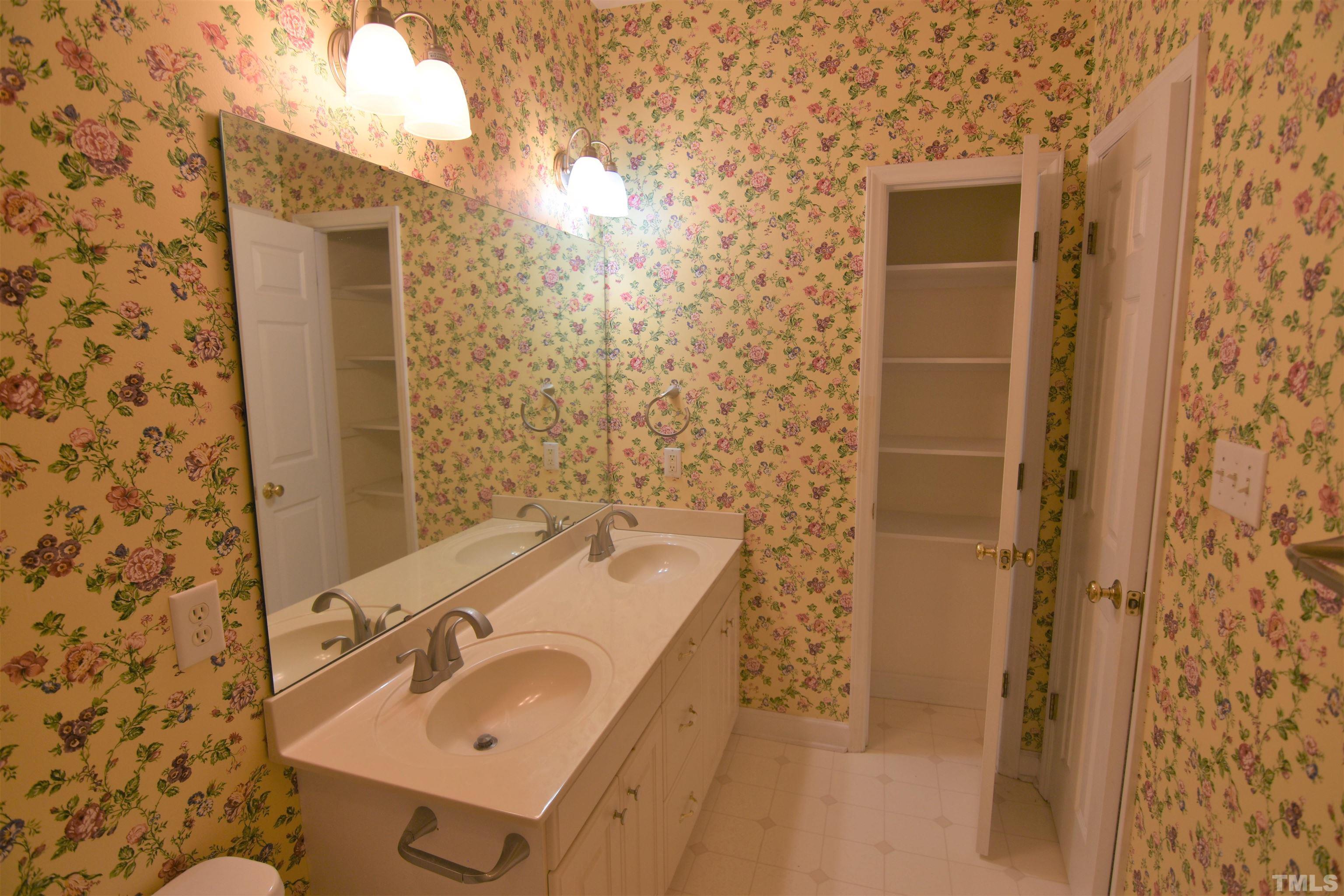 1025 Red Brick Road Garner, NC 27529 - Photo 26 of 30 a bathroom with a sink and mirror