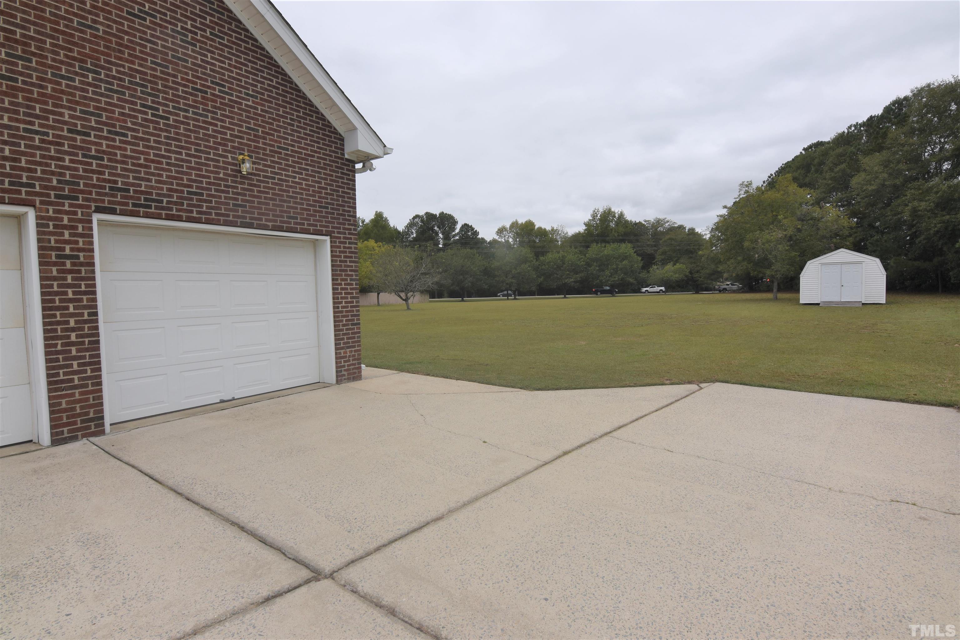 1025 Red Brick Road Garner, NC 27529 - Photo 30 of 30 a front view of a house with a yard and garage