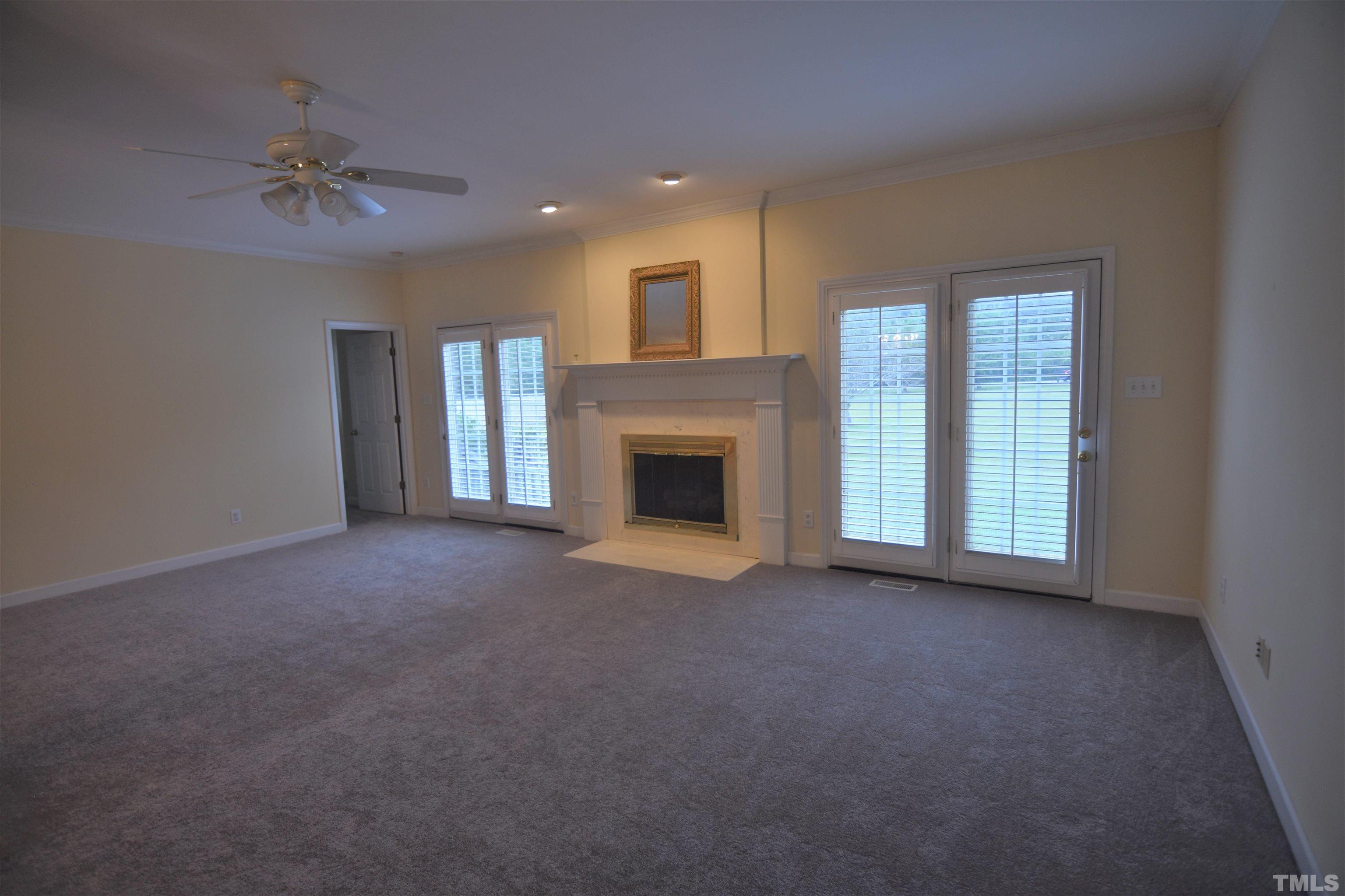 1025 Red Brick Road Garner, NC 27529 - Photo 7 of 30 a view of an empty room with a fireplace and a window