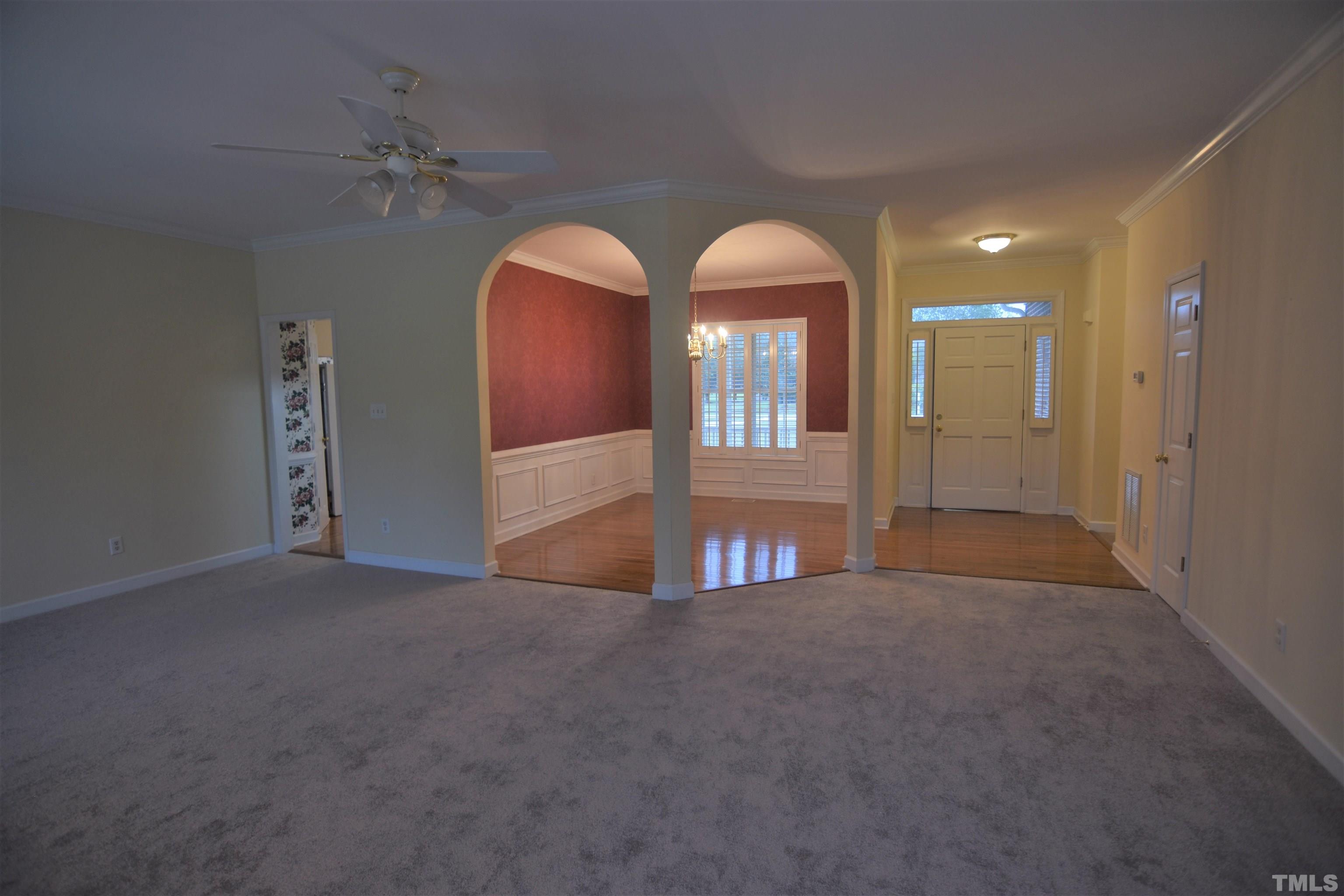 1025 Red Brick Road Garner, NC 27529 - Photo 9 of 30 a view of an empty room with glass door and chandelier fan