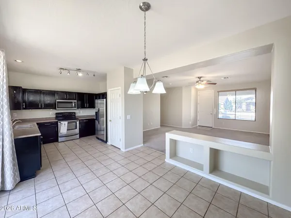 a large kitchen with cabinets and a glass door