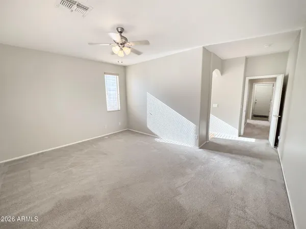 a view of walk in closet with empty racks