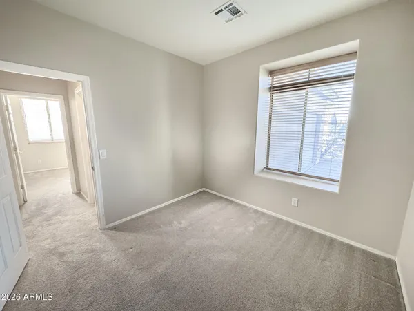 an empty room with windows and closet
