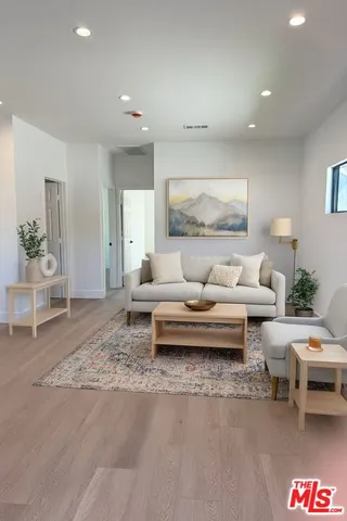 a living room with furniture and a potted plant
