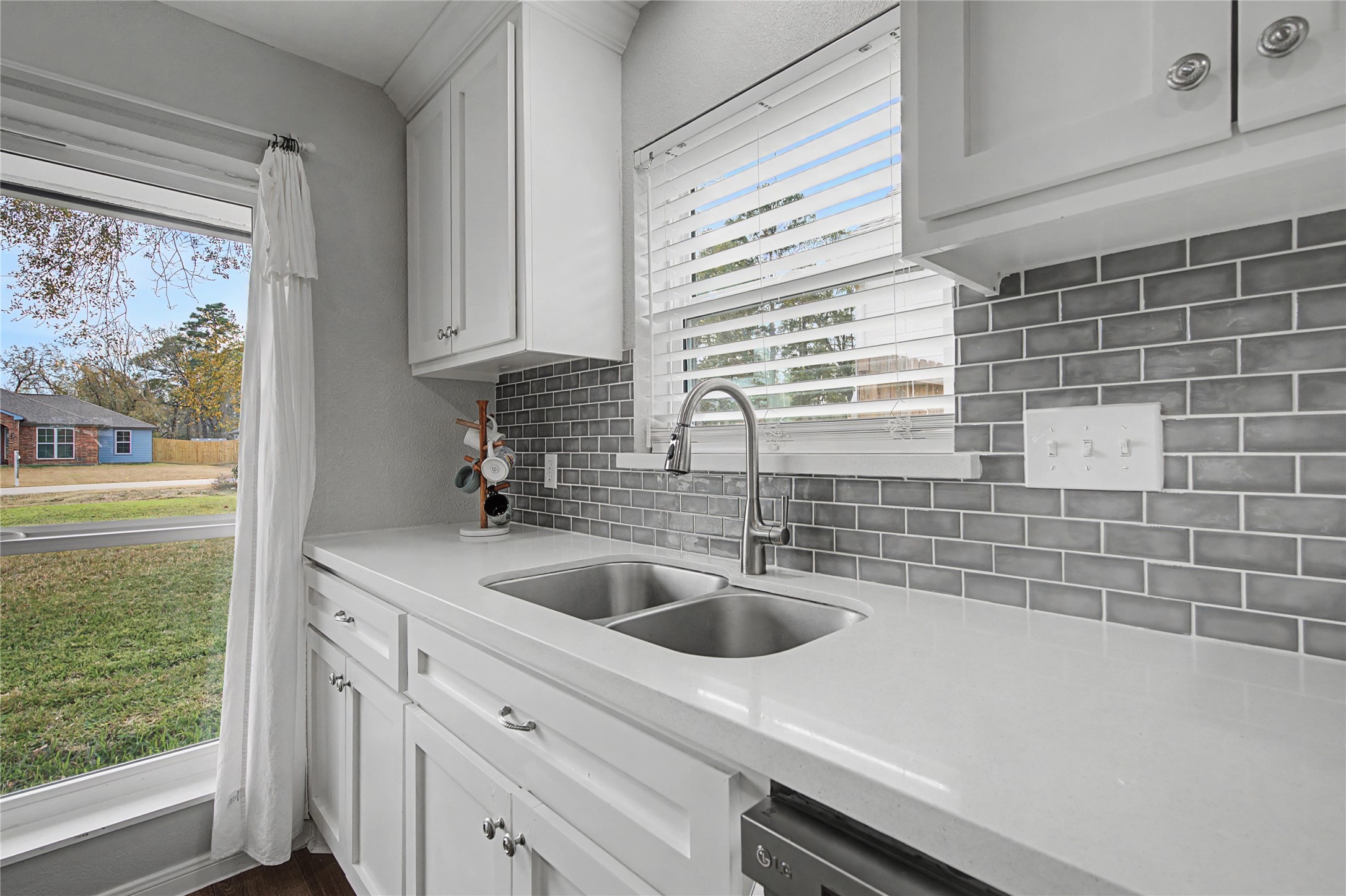 1719 Eastvale Drive Spring, TX 77386 - Photo 12 of 34 The kitchen opens seamlessly to the main living space and offers modern updates with quartz countertops, refreshed cabinetry, and tile backsplash.