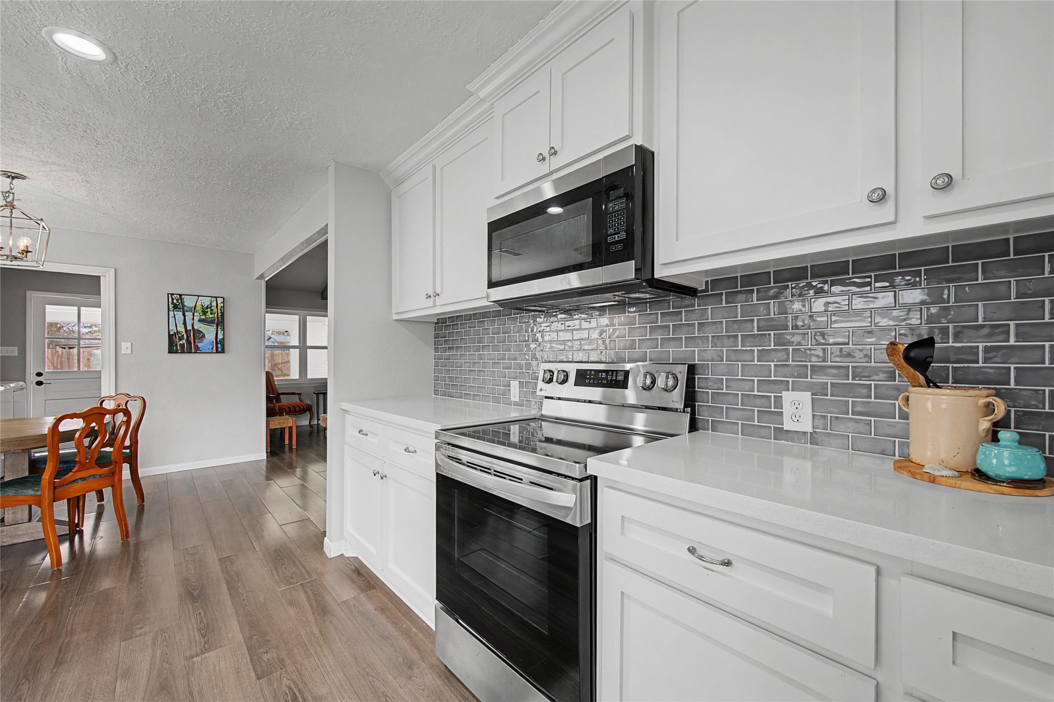 1719 Eastvale Drive Spring, TX 77386 - Photo 13 of 34 The kitchen opens seamlessly to the main living space and offers modern updates with quartz countertops, refreshed cabinetry, and tile backsplash.
