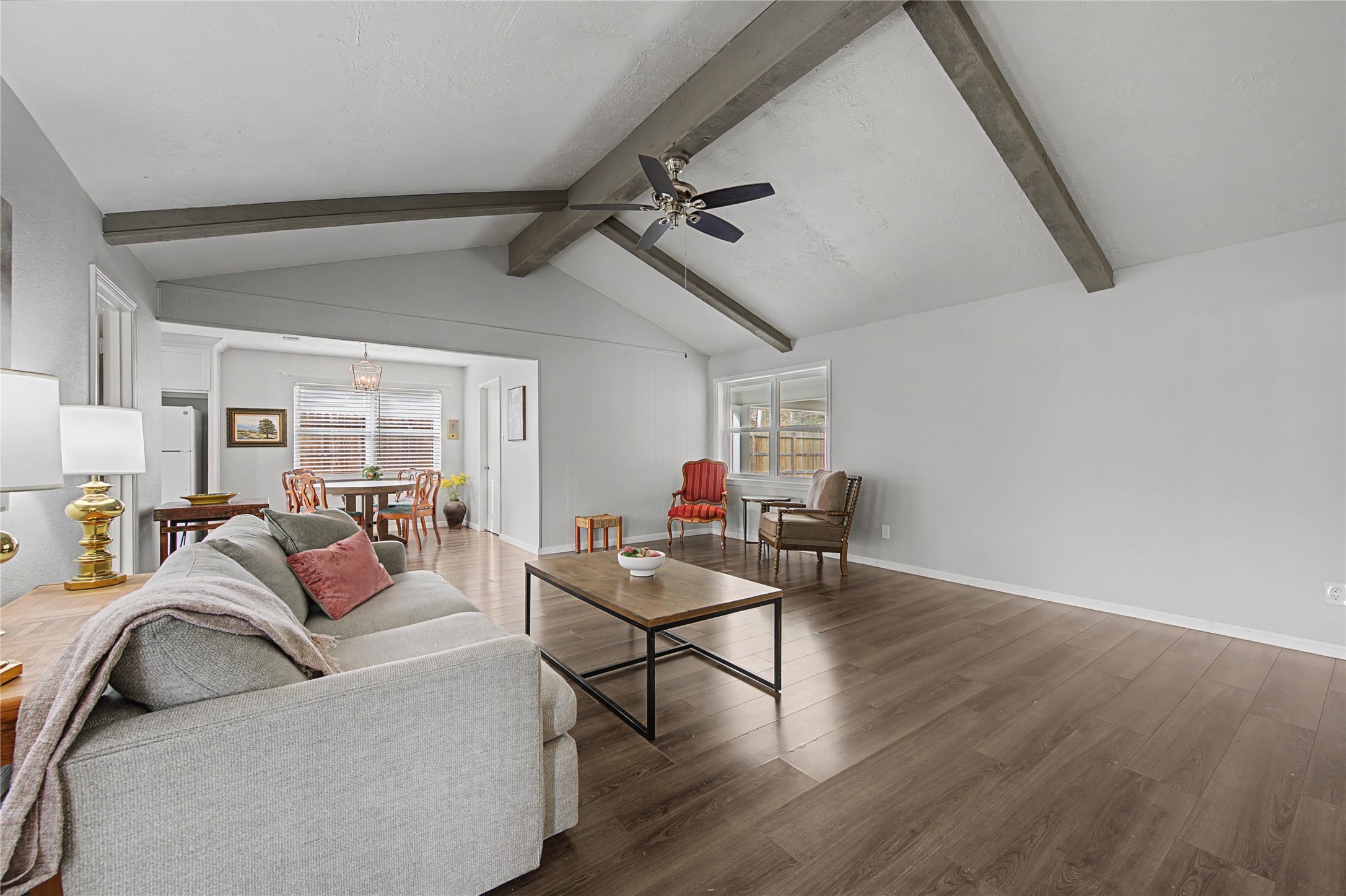 1719 Eastvale Drive Spring, TX 77386 - Photo 9 of 34 The open living area features exposed beam ceilings and neutral finishes. It's open to the breakfast area and the kitchen for added convenience.